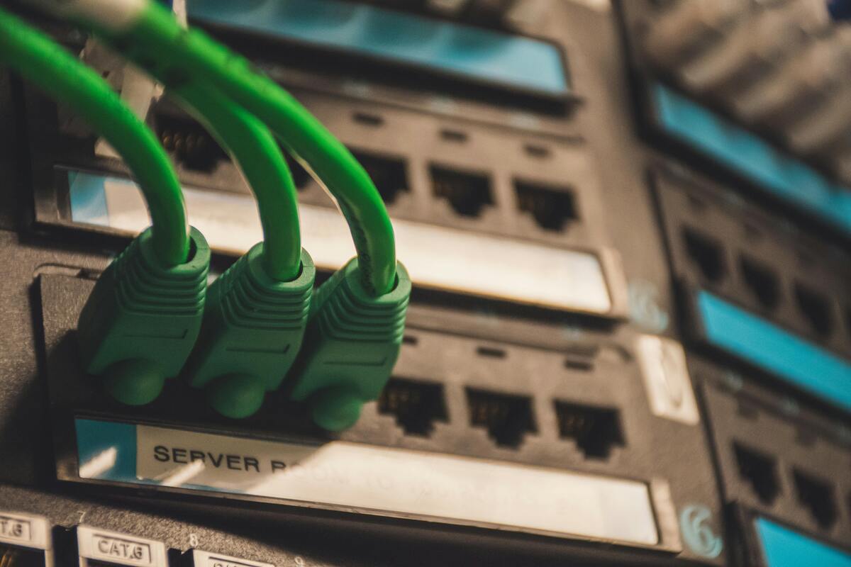 Close-up of green network cables plugged into server ports